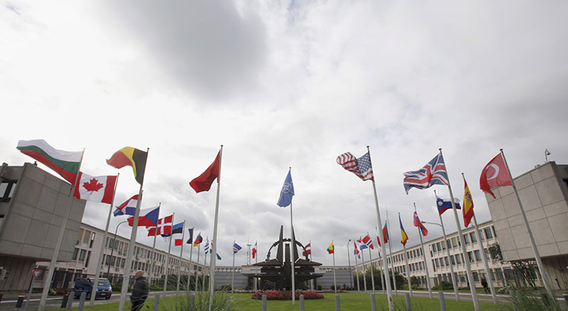 Flags of the NATO allies wave in the wind outside NATO headquarters in Brussels on Wednesday, Oct. 5, 2011. (AP Photo)