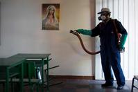 A city worker sprays insecticide to kill mosquitoes after class hours at a school in Cucuta, capital of Norte de Santander state, on Colombia's northeastern border with Venezuela.