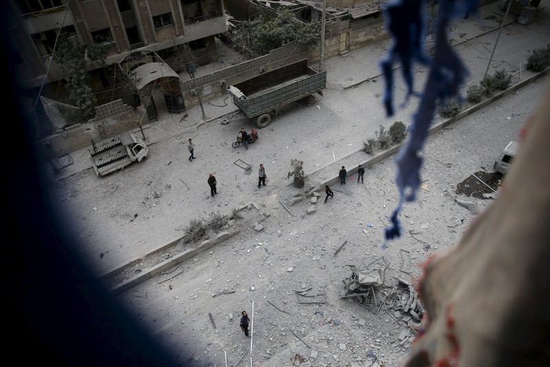 People inspecting the damage at a site hit by Russian-backed pro-Syrian government forces' airstrikes in the moderate held Douma neighborhood of Damascus, Syria.