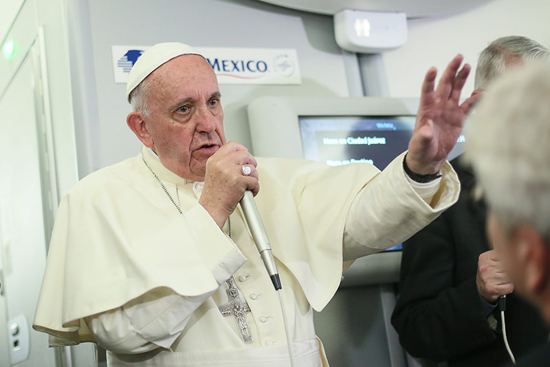 In this photo taken Wednesday, Feb. 17, 2016 Pope Francis meets journalists aboard the plane during the flight from Ciudad Juarez, Mexico to Rome, Italy. (AP Photo)