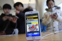 The Apple Pay app running on an iPhone at an Apple Store in Beijing, China.