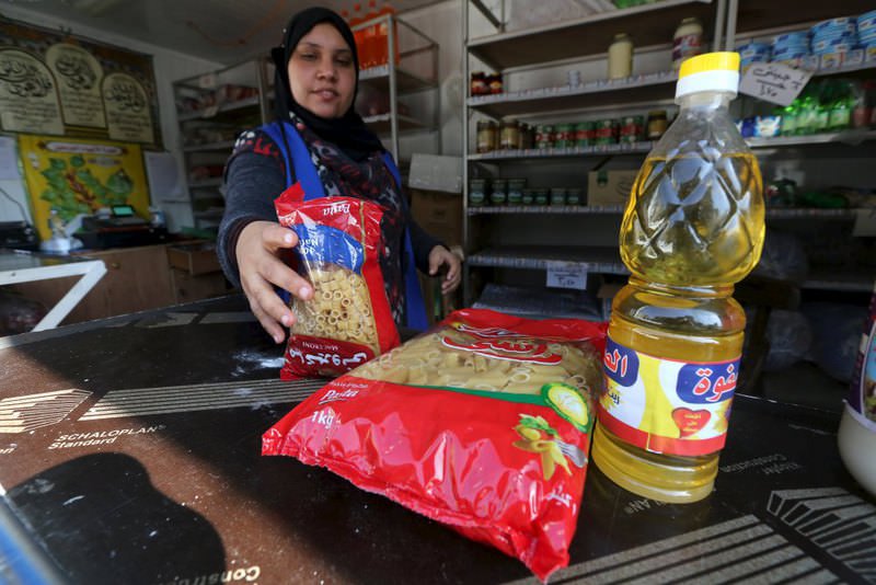 An employee sells subsidized food commodities at a government-run supermarket in Cairo, Egypt. (Reuters Photo)