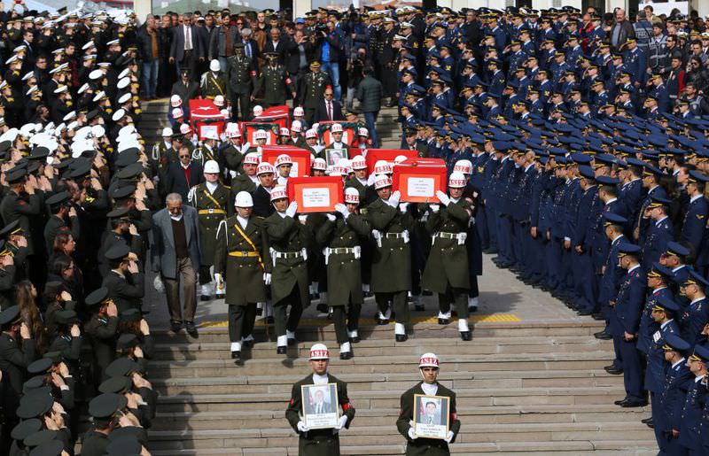 Honor guards carry the coffins of eight victims of the terror attack at Friday's funerals at Ankara's Kocatepe Mosque. (AFP Photo)