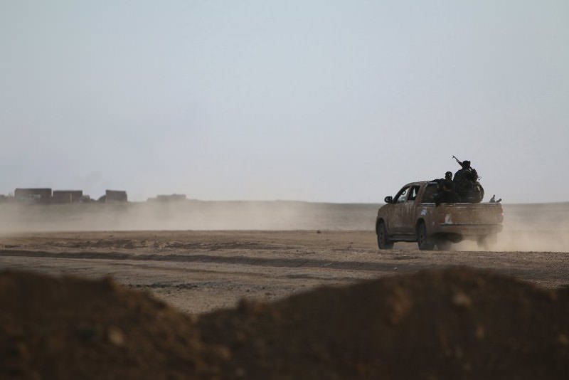 Fighters from the Democratic Forces of Syria driving to position themselves in Ghazila village after taking control of the town in the southern countryside of Hasaka, Syria.