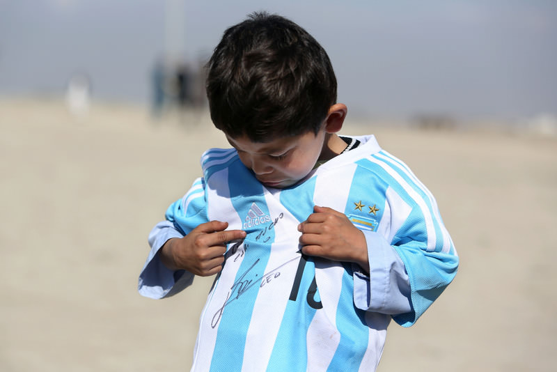 Five-year-old Murtaza Ahmadi pictured wearing homemade 'Messi 10