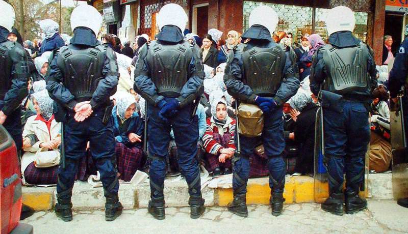 Police waiting in front of imam-hatip school students who were not allowed to enter their school in 2001 due to the past headscarf ban in Turkish politics.