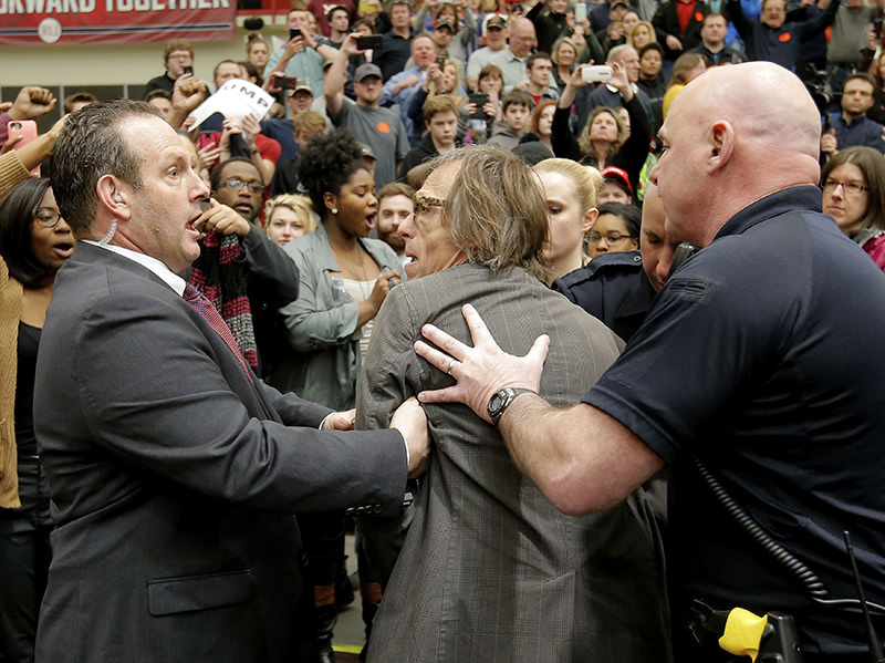 Photographer Christopher Morris is removed by security officials as Trump speaks during a campaign event in Virginia Feb 29, 2016 (Reuters)