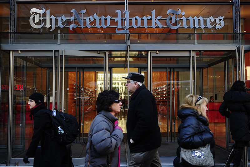 People walk by the entrance to US newspaper 'The New York Times' in New York, in this March 8, 2011 (AFP Photo)