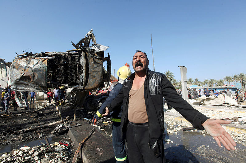 A man reacts at the site of a bomb attack at a checkpoint in the city of Hilla, south of Baghdad, March 6, 2016 (Reuters)