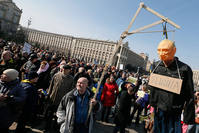 Protester holds a symbolic gibbet with an effigy of Putin and plate on it breast reading like 'Killer' during their rally in downtown Kiev, Ukraine, 06 March 2016 (EPA).