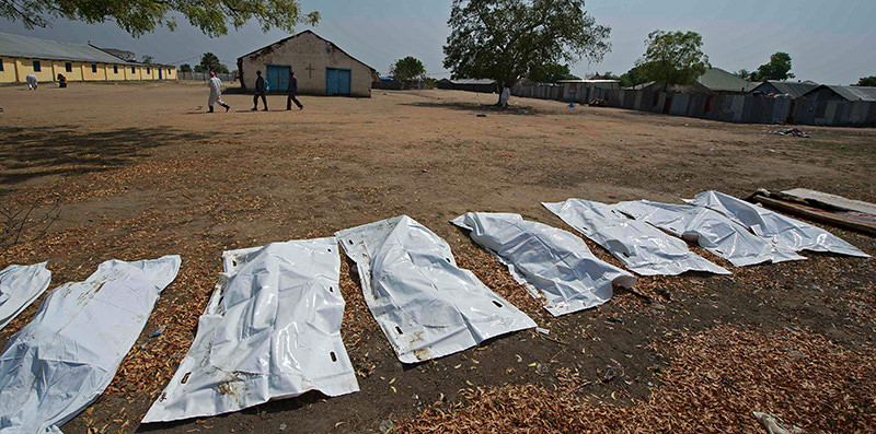 This file photo taken on January 27, 2014 shows sheets covering the bodies of 16 people, allegedly civilians killed when they took cover near Leudit church in Bor town, according to the South Sudanese military. (AFP Photo)