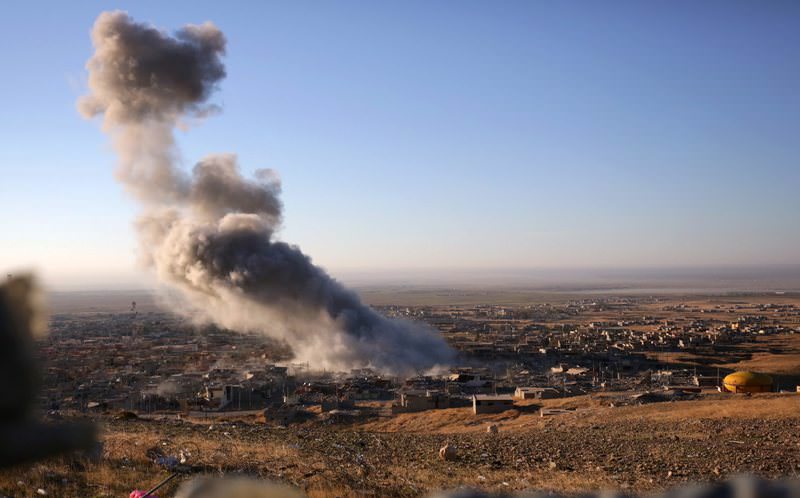 Smoke believed to be from an airstrike billows over the northern Iraqi town of Sinjar.