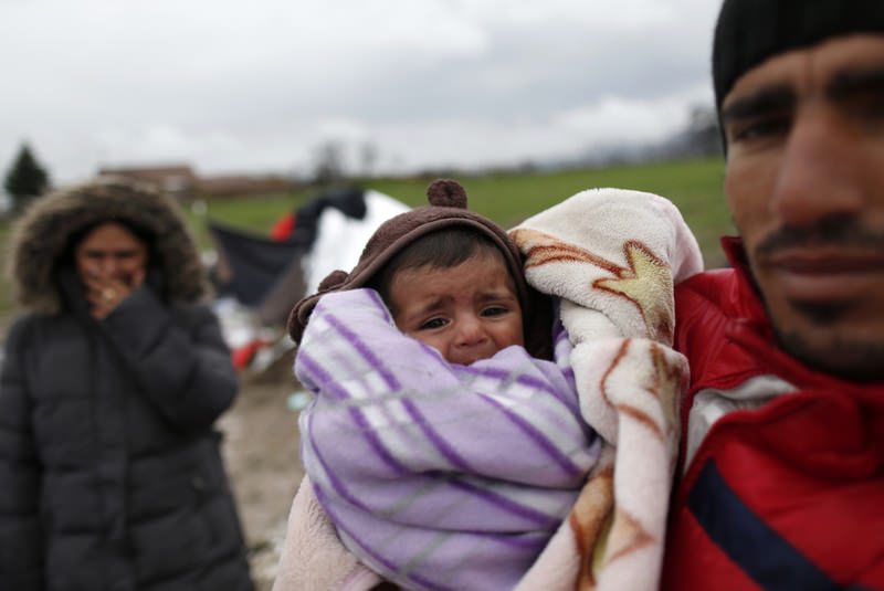 Yousif Shikhmous, a Syrian refugee holds his baby in an improvised camp on the border between Macedonia and Serbia near the northern Macedonian village of Tabanovce on March 11.