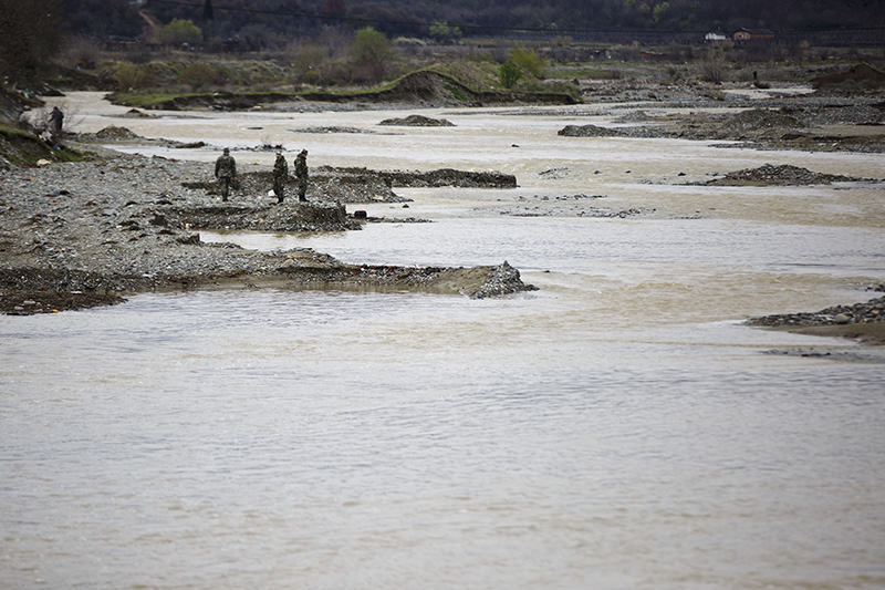 Macedonian soldiers scout for bodies of drowned refugees on the river bank of Suva Reka river near the southern Macedonian town of Gevgelija, March 14, 2016. (AP)