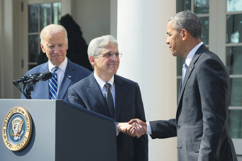 Vice President Joe Biden (L) looks on as Supreme Court nominee Merrick Garland (C) shakes hands with President Obama in front of the White House on March 16.