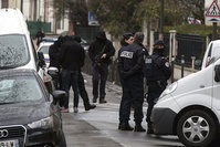 Police officers and investigators stand outside a building where an anti-terrorism operation took place in Argenteuil, near Paris, 25 March 2016 (EPA Photo)