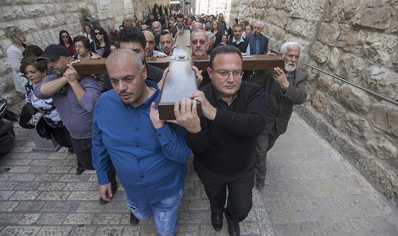 Catholic pilgrims carrying the cross as the march at the Via Dolorosa in the old city of Jerusalem, during the Good Friday part of the Easter procession, 25 March 2016. (EPA Photo)
