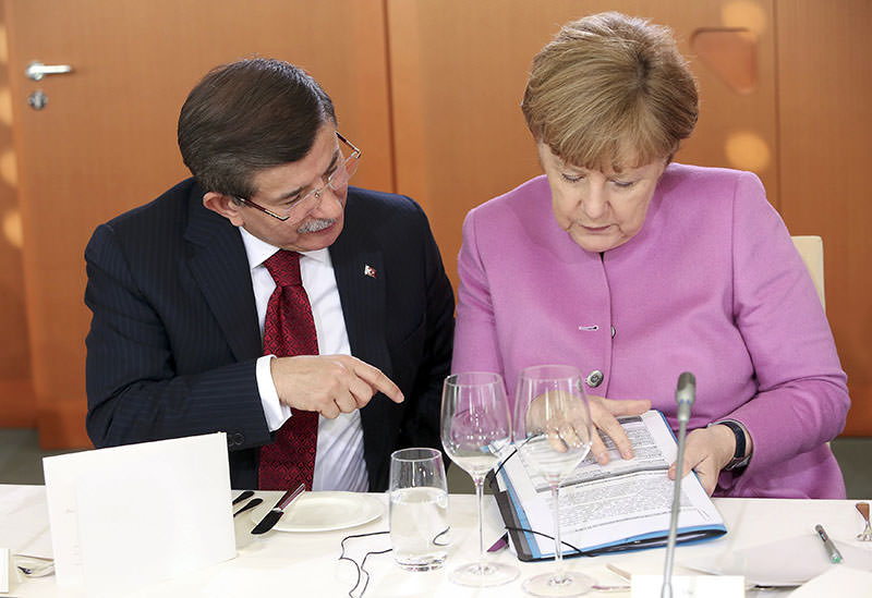PM Davutou011flu, Merkel speak before a lunch during German-Turkish government consultations at the Chancellery in Berlin, Germany, Jan 22, 2016 (Reuters) 