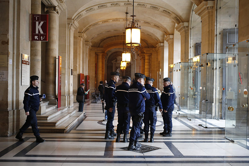 French gendarmes patrol in the Paris hall of Justice, Wednesday, March 30, 2016 while Frenchman Reda Kriket is being questioned by a magistrate. (AP Photo)