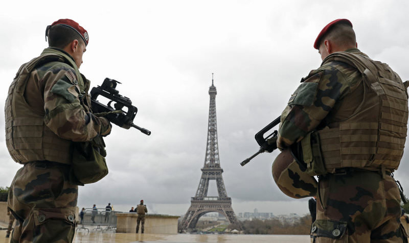 French paratroopers patrol near the Eiffel tower in Paris on March 30. France and Belgium have intensified their security measures in urban centers following terror attacks.