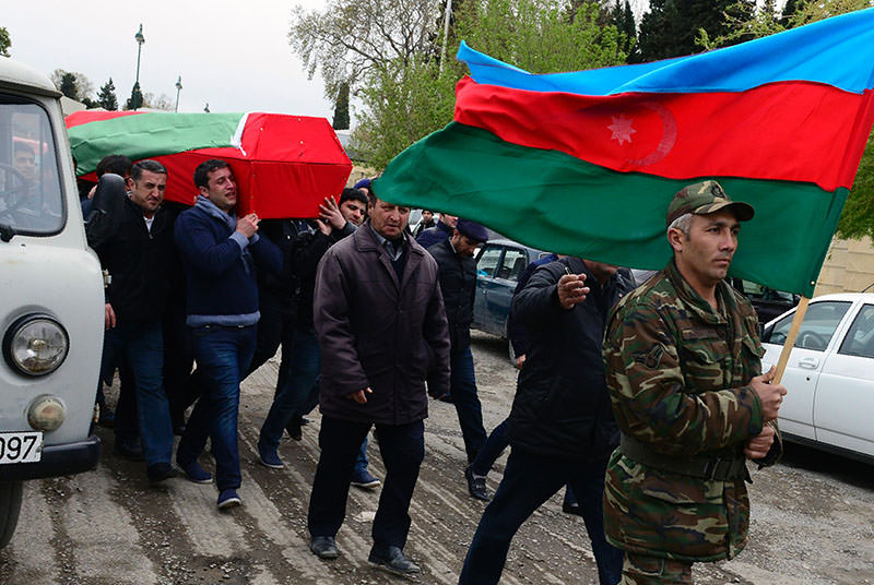 Men carry coffin of Azerbaijan's serviceman, who was killed on April 2 during clashes between Armenian, Azeri forces in Armenian-seized Azerbaijani region of Karabakh (AFP)