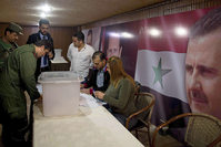 Syrian policemen cast their votes at a polling station during the parliamentary election in Damascus, Syria, Wednesday, April 13, 2016 (AP Photo)