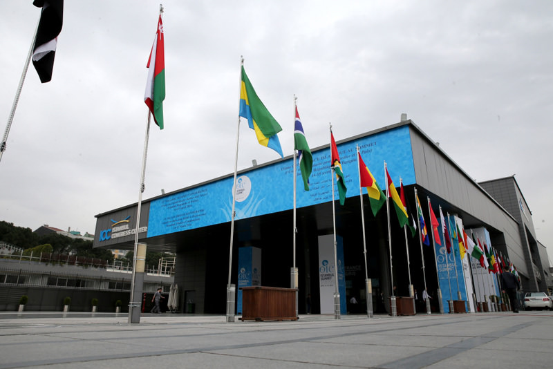 Flags of OIC countries and logo fly outside the Istanbul Congress Center. Police closed down roads leading to the event venue for the summit.