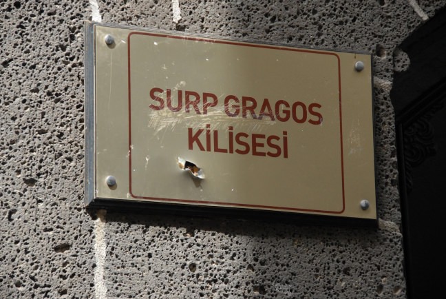 The sign of Surp Giragos Church is seen with bullet marks, which occurred as a result of PKK terror attacks