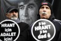 Two men carrying placards reading ,For Hrant, For Justice, at a ceremony to remember the late journalists on Jan. 19, 2016.
