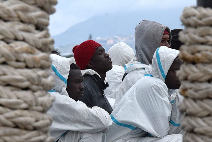 This file photo taken on February 1, 2016 shows men waiting to disembark from the Italian Coast Guard vessel ,Dattilo, in the port of Messina, Sicily, following a rescue operation of migrants and refugees at sea (AFP Photo)