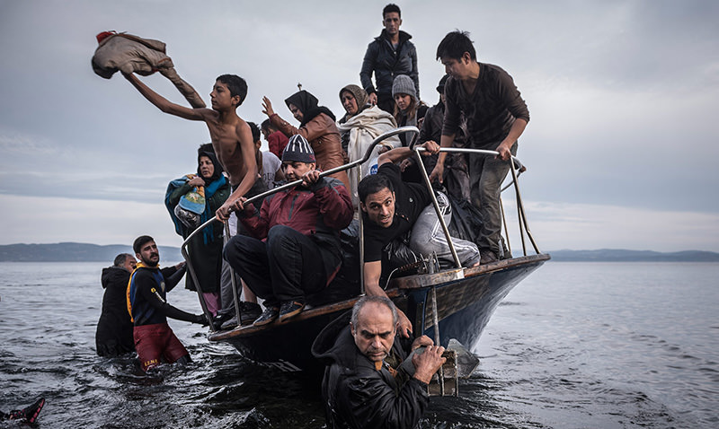 In this Nov. 1, 2015 photo by Sergey Ponomarev, migrants arrive by a Turkish boat near the village of Skala, on the Greek island of Lesbos (AP Photo)