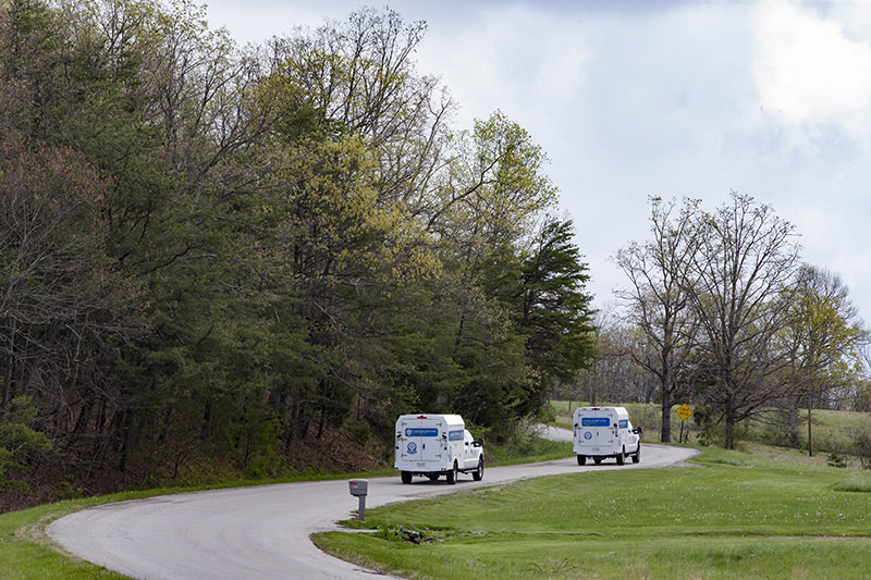 Crime scene investigation vehicles drive up Union Hill Road as they approach the location of a reported multiple shooting, Friday, April 22, 2016, in Pike County, Ohio. (AP Photo)