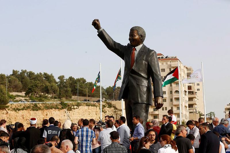 Palestinians and South Africans stand during the revealing of a giant statue of Nelson Mandela in the West Bank city of Ramallah, 26 April 2016. (EPA Photo)