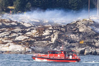 A search and rescue vessel patrols off the island of Turoey, near Bergen, Norway, as emergency workers attend the scene of a helicopter crash believed to have 13 people aboard, Friday April 29, 2016 (AP Photo)