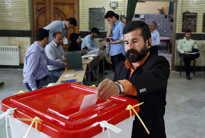An Iranian voter casts his ballot for the parliamentary runoff elections in a polling station at the city of Qods about 12 miles (20 kilometers) west of the capital Tehran, Iran, Friday, April 29, 2016 (AP Photo)