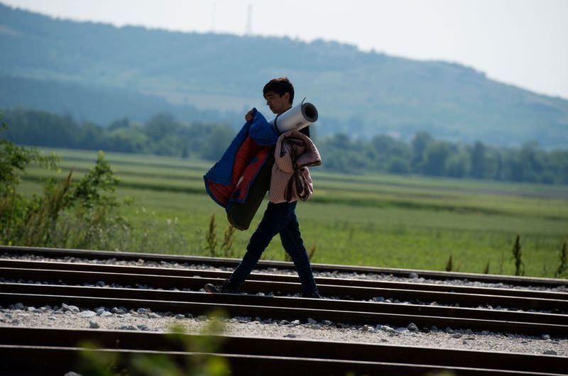 A young man walks along rail tracks at a makeshift camp for refugees at the Greek-Macedonian border near the village of Idomeni on May 1.
