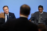 British Prime Minister David Cameron (L) and Nigerian President Muhammadu Buhari listen during a panel discussion at the Anti-Corruption Summit in London on Thursday. (Reuters Photo)