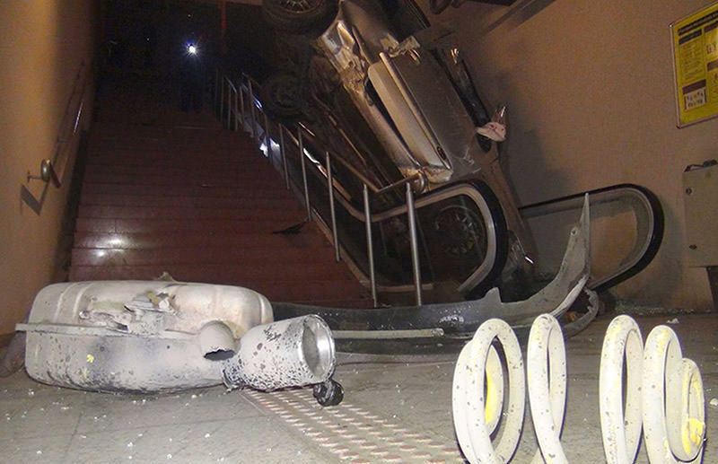 Car lands on metro escalator after accident in Bursa. (DHA Photo)