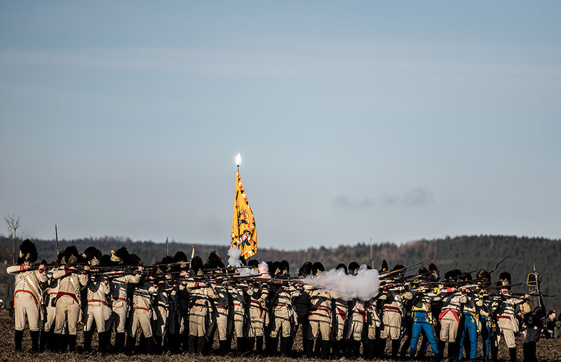 History enthusiasts dressed in regiment costumes fire their rifles in the re-enactment of the Austerlitz battle. Dec. 3, 2016. (AA Photo)