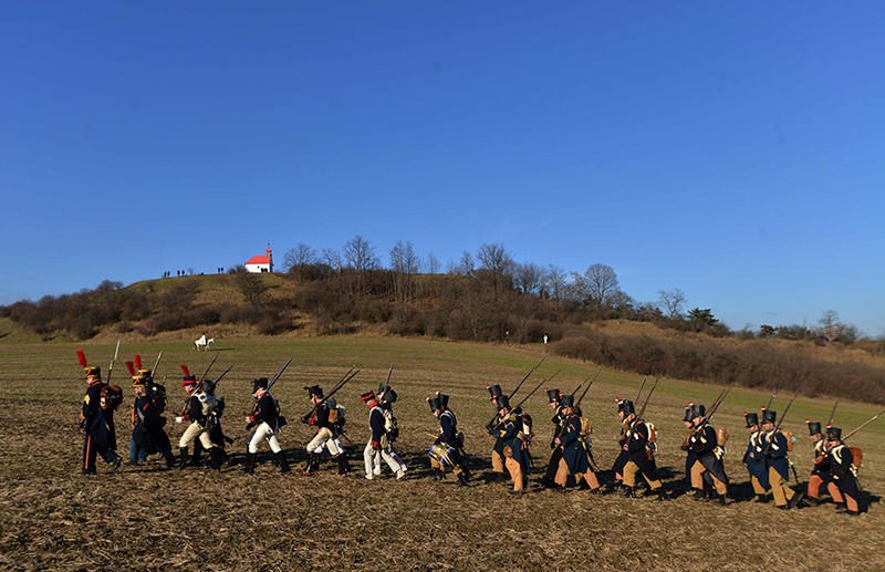 Historical re-enactment enthusiasts dressed as soldiers march on the Austerlitz battle field on December 3, 2016 prior a re-enactment of Napoleon's famous battle of Austerlitz. (AFP Photo)