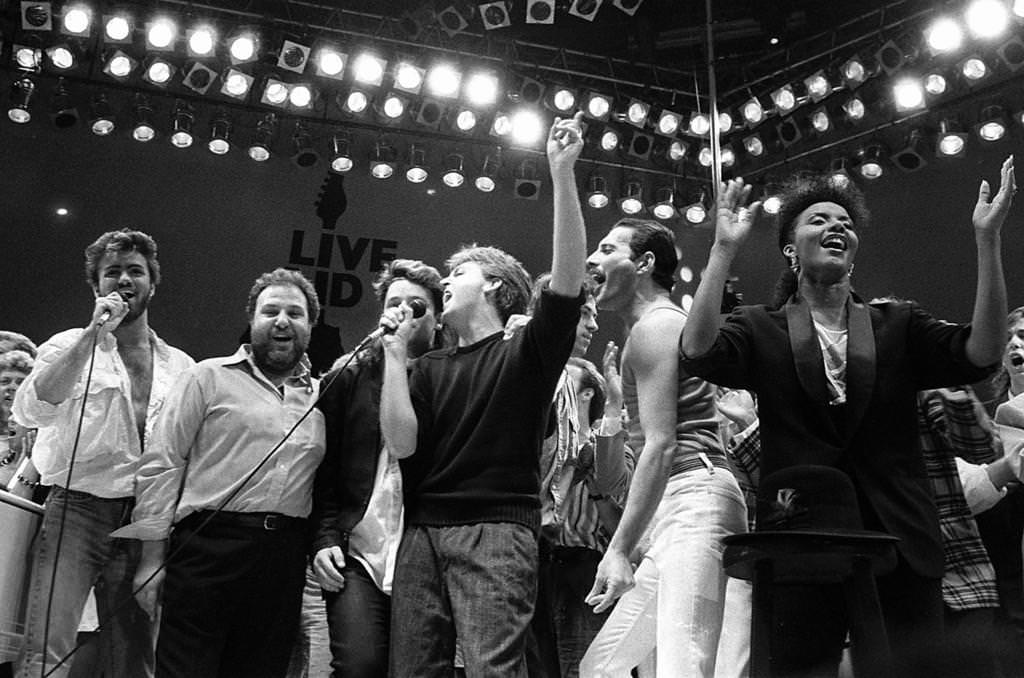 In this July 13, 1985 photo, Michael (L), promoter Harvey Goldsmith, U2’s Bono, Paul McCartney, organizer Bob Geldof and Queen’s Freddie Mercury join in the finale of the Live Aid concert. (AP)