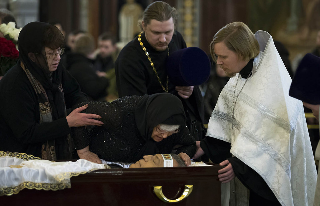 Mother of Andrei Karlov, Maria, right, kisses her son during a religious service for killed Russian ambassador to Turkey, Andrei Karlov inside the Christ the Saviour Cathedral in Moscow