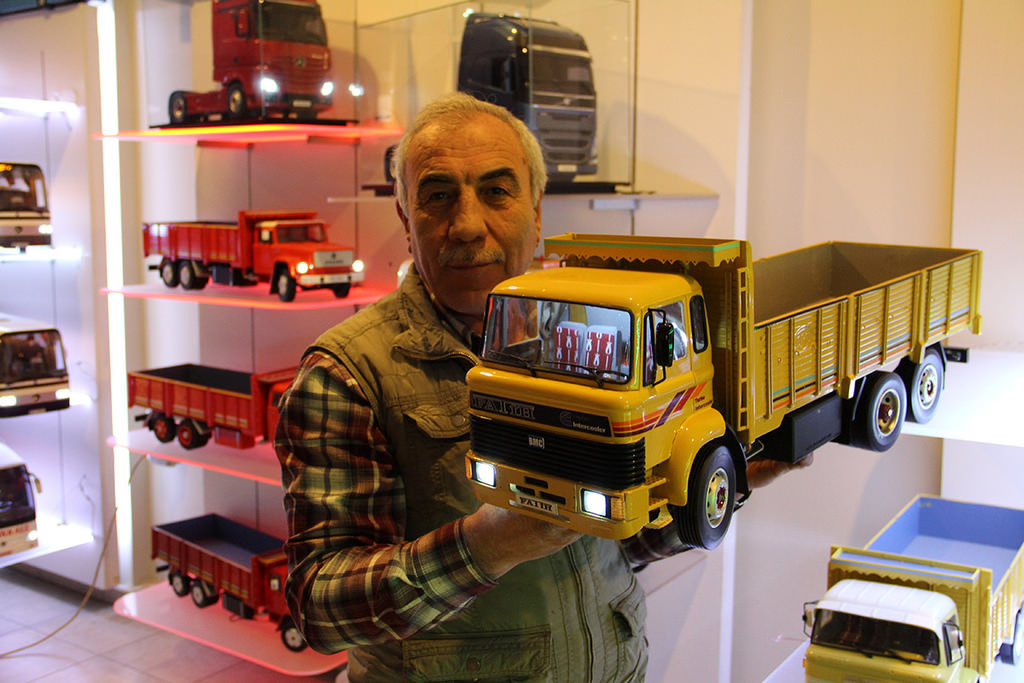 İsmail Aydınlıoğlu holding a yellow BMC Fatih model truck at his model car gallery in Western Aydın province (AA Photo)