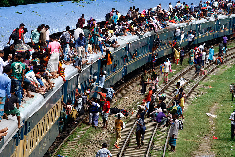 People overload the roof of a train as they travel to 