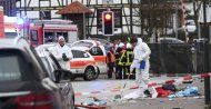 Police and rescue workers stand next to the scene of the accident with a car that is said to have crashed into a carnival parade in Volkmarsen, central Germany, Monday, Feb. 24, 2020. (AP Photo)