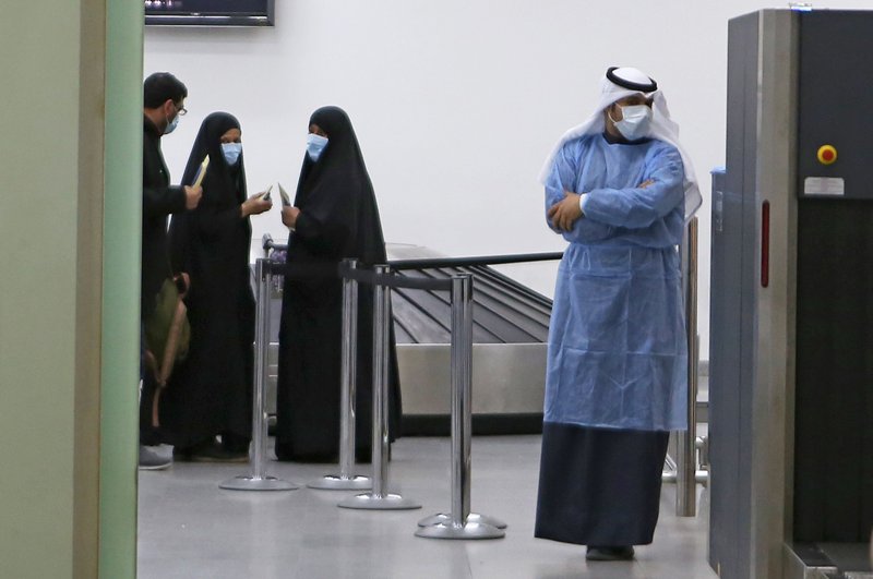 People coming back from Iran wait before being taken to a hospital to be tested for coronavirus, at Sheikh Saad Airport in Kuwait City, Kuwait, Feb. 22, 2020. (AFP Photo)
