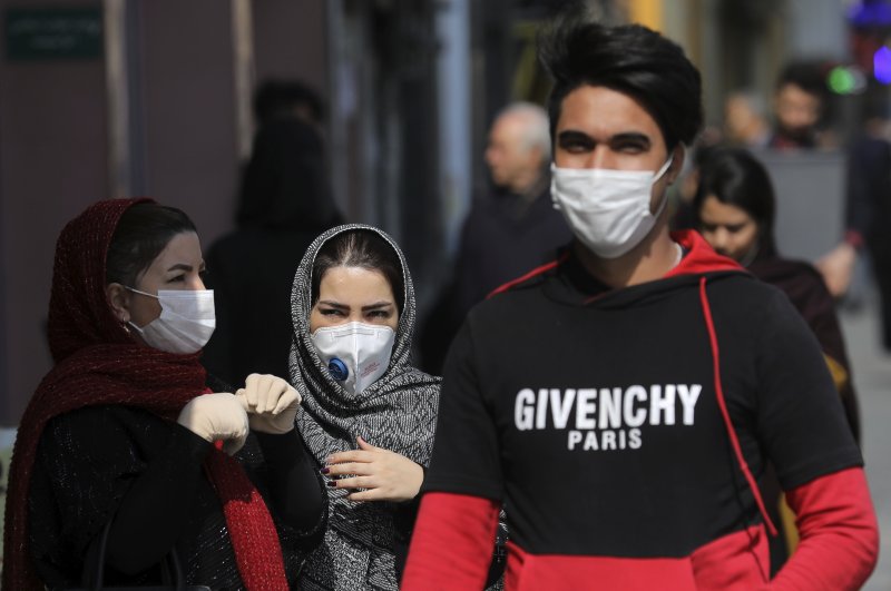 Pedestrians wear masks to help guard against the coronavirus, in downtown Tehran, Iran, Sunday, Feb. 23, 2020. (AP Photo)