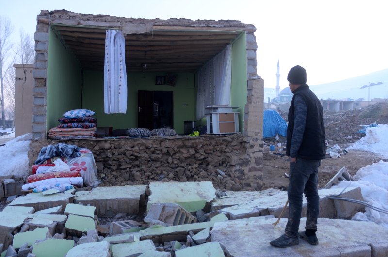 A man looks at a house whose wall collapsed in the earthquake in Özpınar village, Van, Feb. 24, 2020. (İHA Photo)