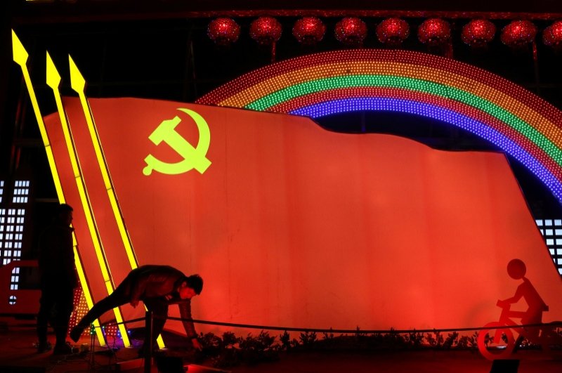 Men check on a light installation in a shape of the party flag of the Communist Party of China, that is set up to celebrate the upcoming Chinese Lunar New Year, in Jining, Shandong. (Reuters Photo)