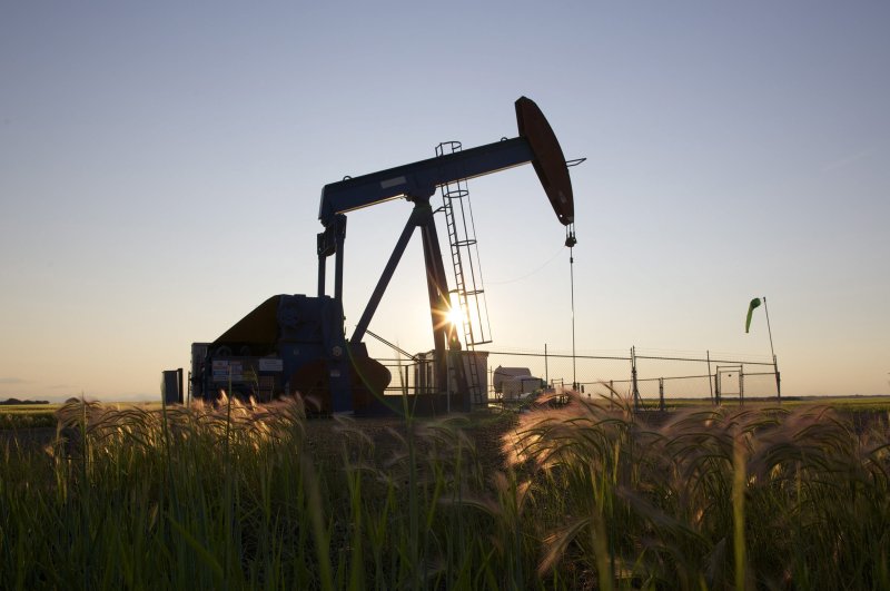 An oil pump jack pumps oil in a field near Calgary, Alberta, July 21, 2014. (Reuters Photo)